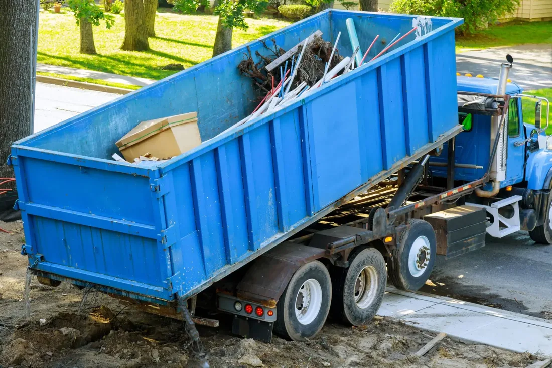 Commercial roll-off dumpster at a business job site