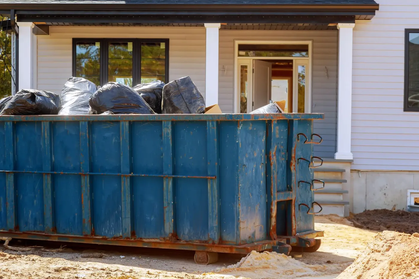 Blue roll-off dumpster ready for delivery